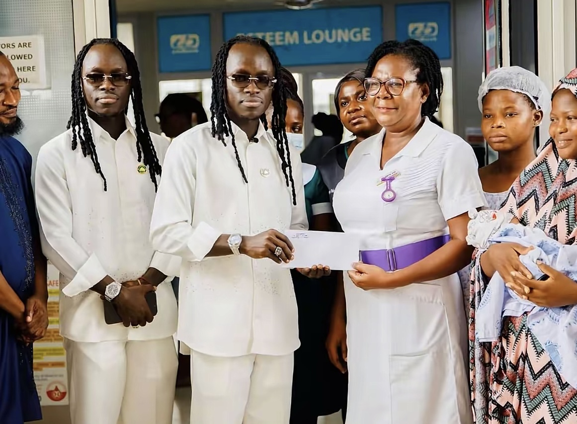 Mystic Twins Foundation presenting donation envelope to nurse